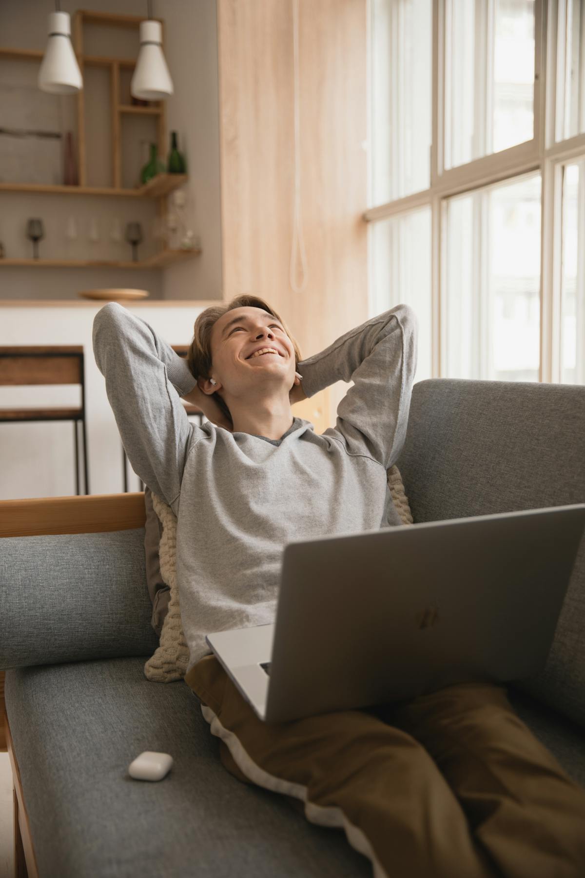 Man sitting on a sofa using a laptop